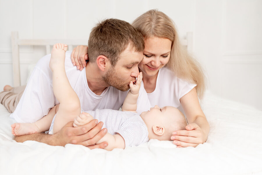 happy-family-mother-father-baby-home-having-fun-baby-crawling-foreground (1) (1)
